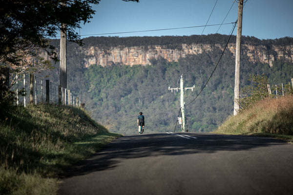 Cyclist on a scenic mountain road overlooking a valley